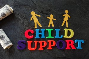 Some rolls of money, the words CHILD SUPPORT spelled out in colorful magnetic letters and three person shapes to pose the questions, how much does a child support lawyer cost in St. Louis Missouri?